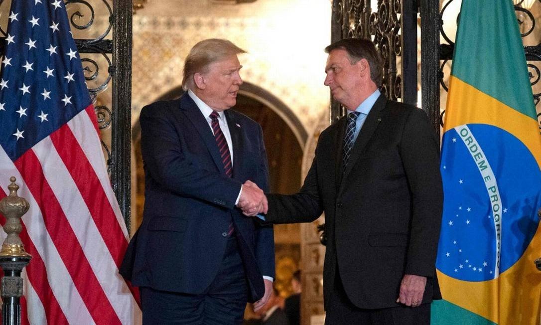 US President Donald Trump L shakes hands with Brazilian President Jair Bolsonaro 